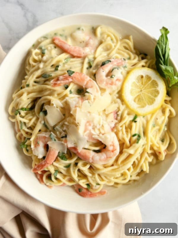 Shrimp Pasta in a Bowl with Lemon Slices and Basil