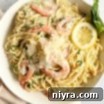 Shrimp Pasta in a Bowl with Lemon Slices and Basil