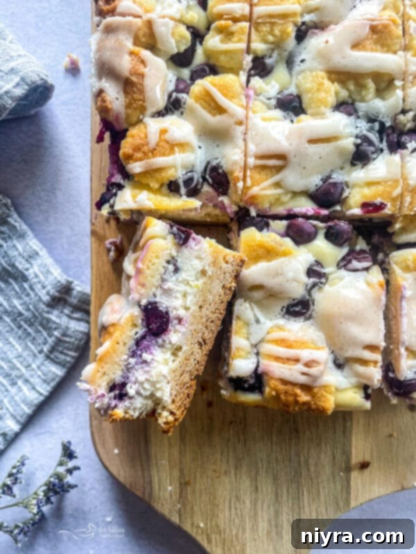 slice blueberry lemon crumb bar filled with cheesecake filling