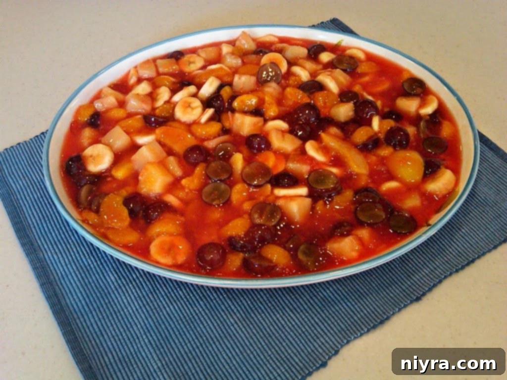 A freshly prepared bowl of Marie's fruit salad, ready to be served at a party.