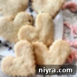 Lavender Shortbread and Lavender Strawberry Dream 26 heart shaped lavender shortbread stacked on a white cloth.