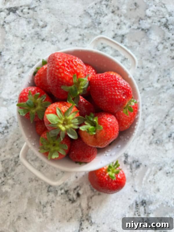 Lavender Shortbread and Lavender Strawberry Dream 8 Fresh, vibrant red strawberries displayed next to a small bowl of dried lavender buds.