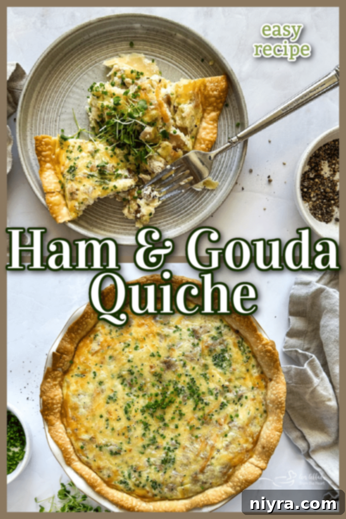 Slices of Ham and Smoked Gouda Quiche on a white plate, garnished with fresh herbs.