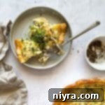 Two slices of Ham and Smoked Gouda quiche on a gray plate.