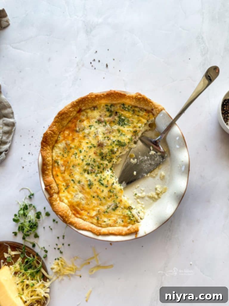 Close-up of baked Ham and Smoked Gouda Quiche with a golden-brown crust.