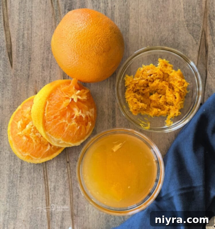 A bowl of freshly squeezed orange juice, a key ingredient for the vibrant cake filling