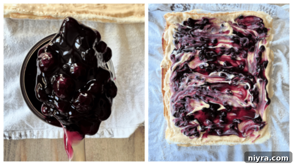 Blueberry pie filling being added to the creamy orange filling on the unrolled cake