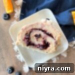 Jelly Cake Roll garnished with fresh blueberries and orange slices
