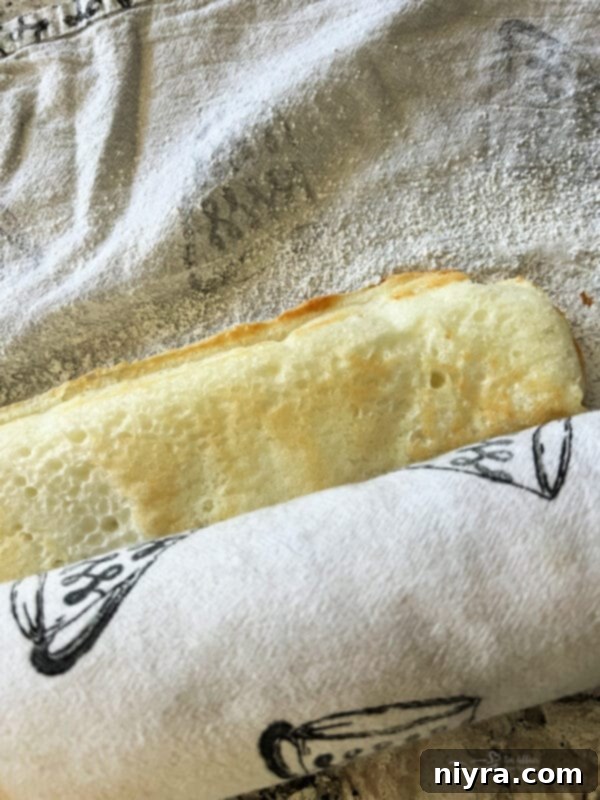 Warm Angel Food Cake expertly flipped onto a sugar-dusted kitchen towel