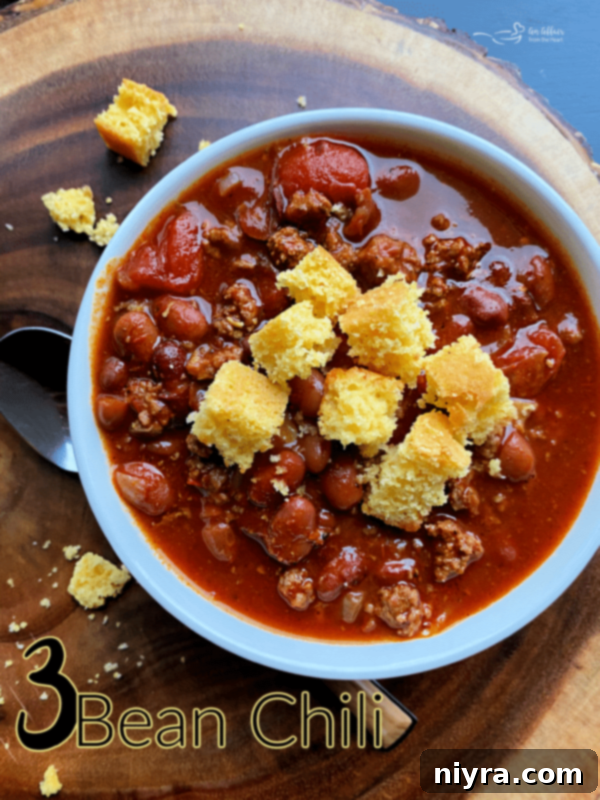 A bowl of Three Bean Chili with cornbread, emphasizing the homemade feel of the meal.
