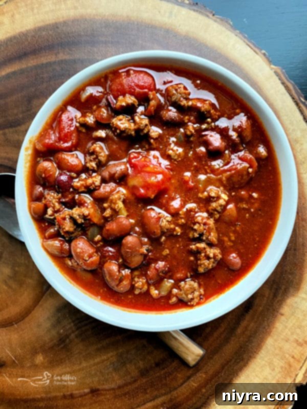 A large pot of simmering Three Bean Chili, ready to be served.