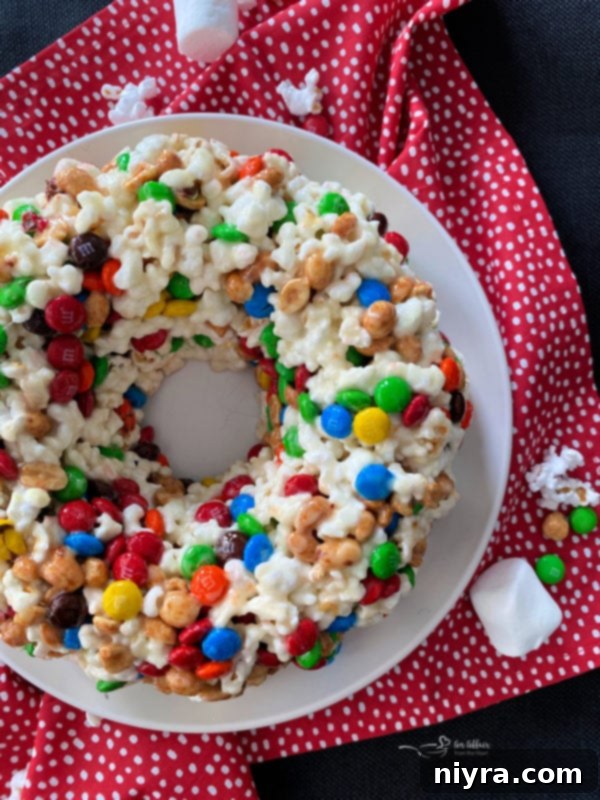 Ultimate Homemade Caramel Chocolate Nut Popcorn 20 Popcorn Cake, a colorful and fun treat, seen from a top-down perspective on a polka dot background