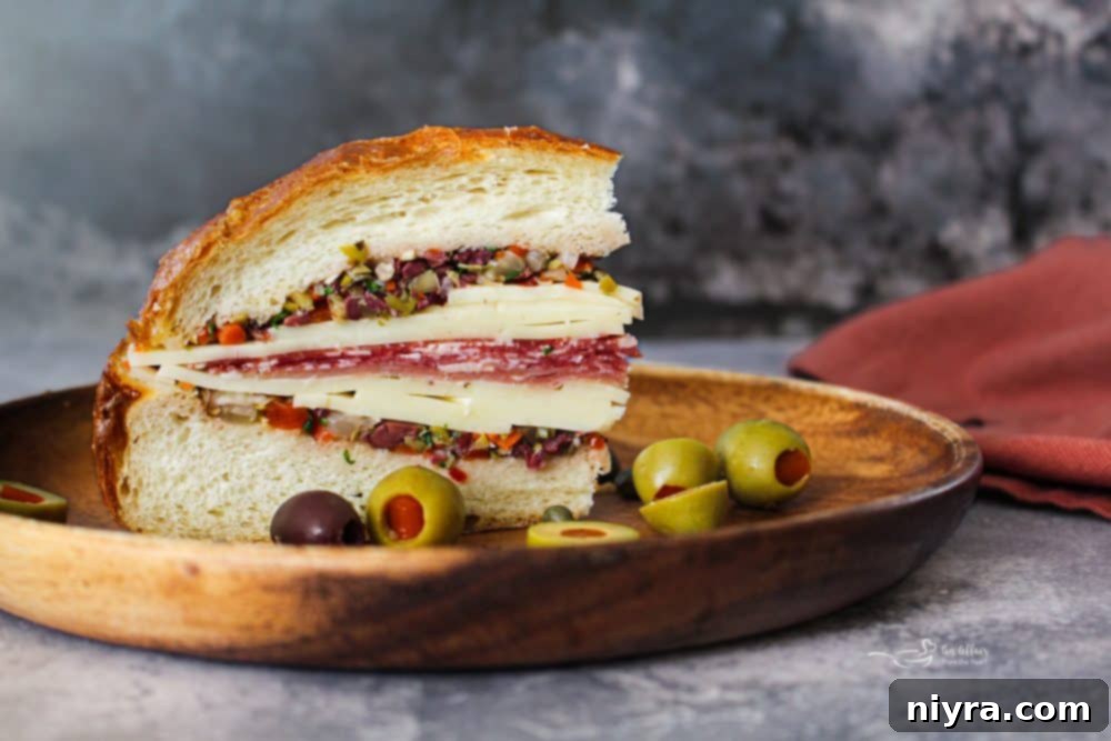 New Orleans Iconic Muffuletta 3 Close-up of a Muffuletta sandwich showing olive salad and deli meats