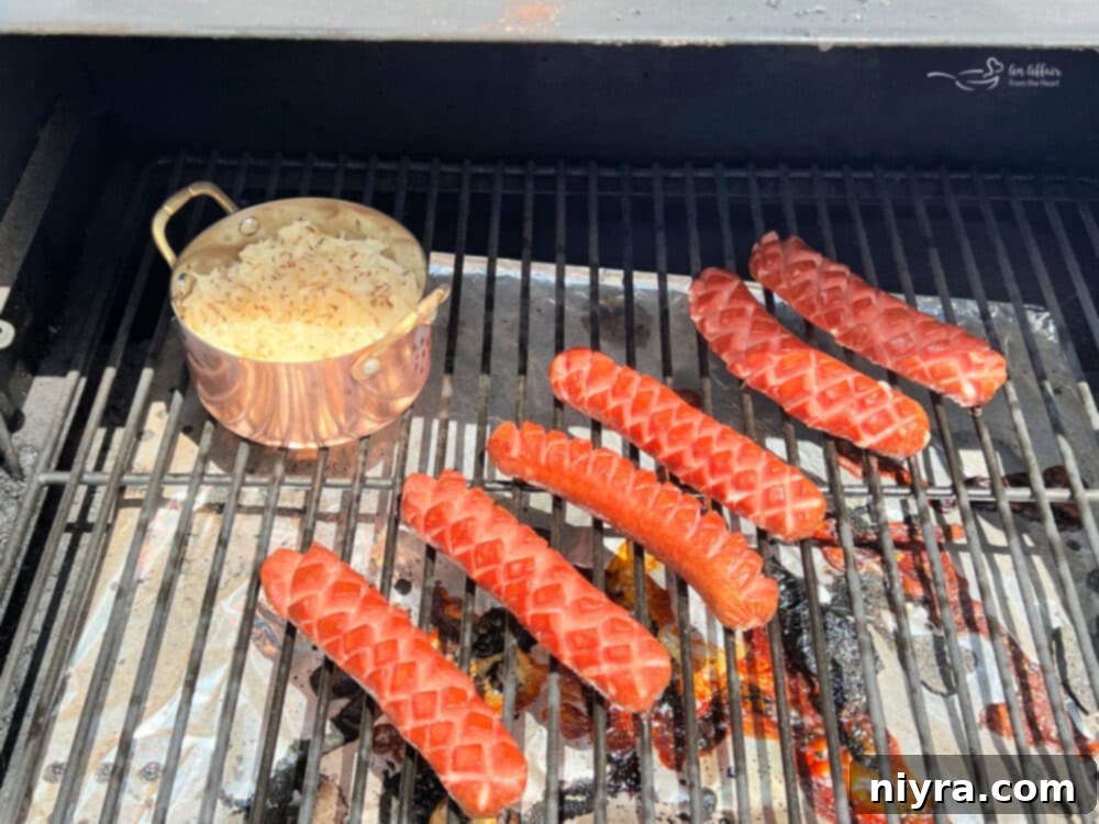 Smoky Dogs with Zesty Kraut 13 Smoked hot dogs cooking on a Traeger grill