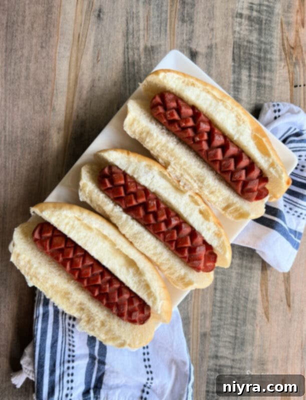 Smoky Dogs with Zesty Kraut 5 Hot dogs with crosshatch scores before smoking