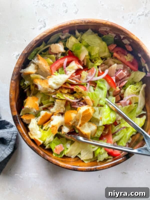 Tossing Little King Salad with dressing and bread