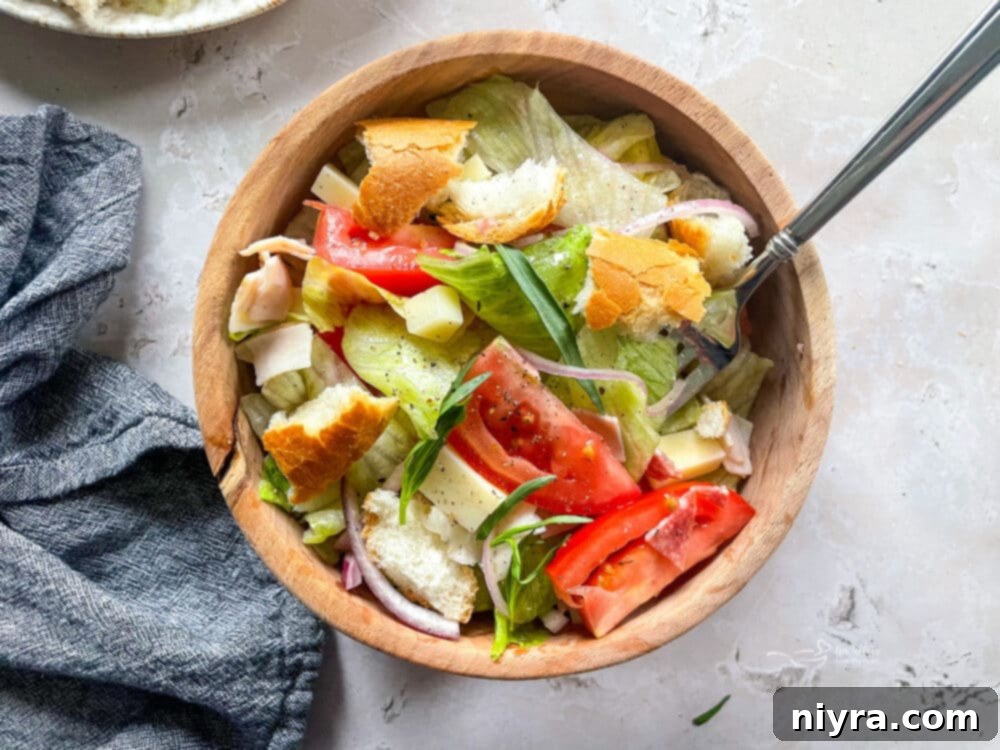 Little King Salad ingredients tossed in a large bowl