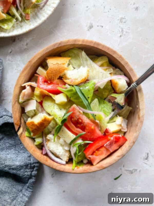 Little King Salad with dressing being added