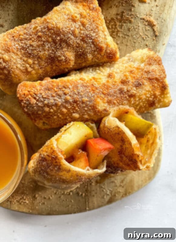 Air Fryer Apple Pie Egg Rolls stacked on a plate