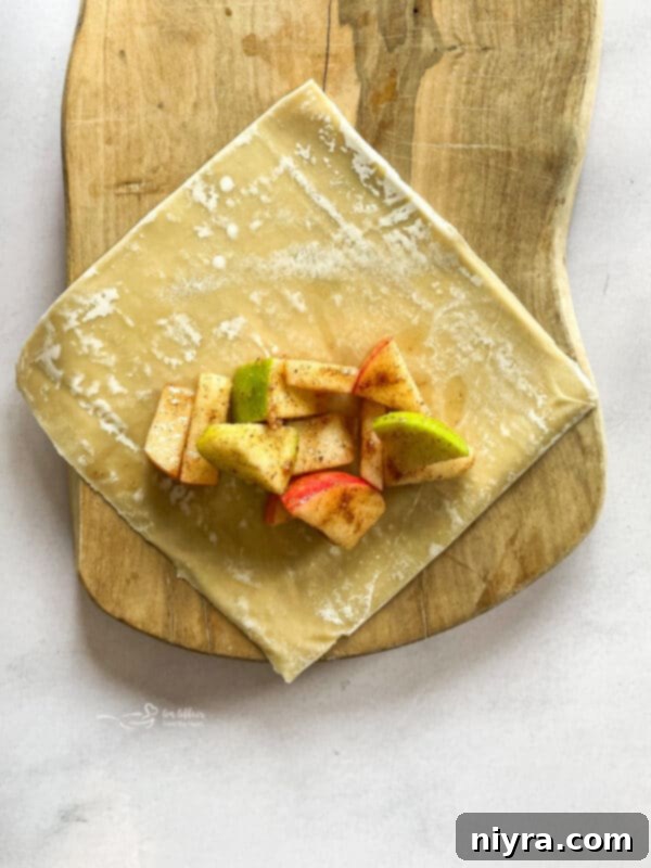 Apple pie filling being mixed in a bowl