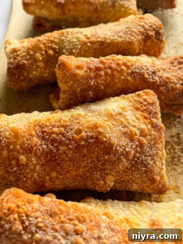 Apple pie egg rolls in an air fryer basket
