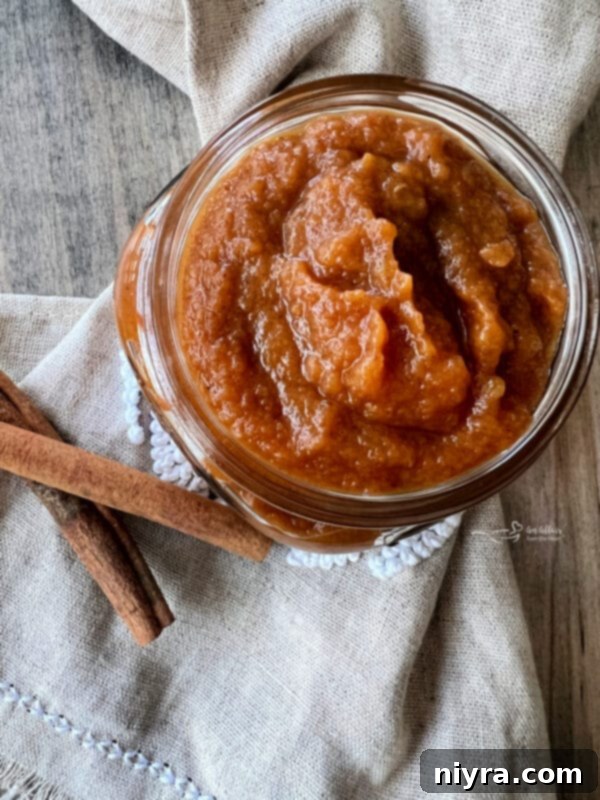 Basket of apples and pumpkin next to spices