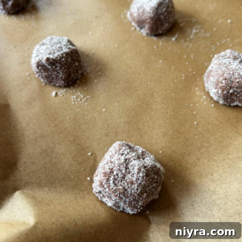 Rolling cookie dough in vanilla sugar