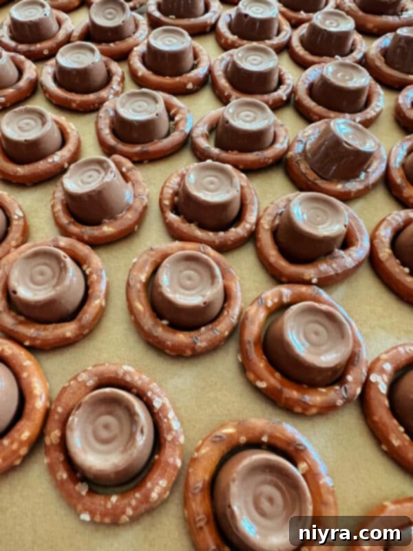 Rolo candies placed in pretzels