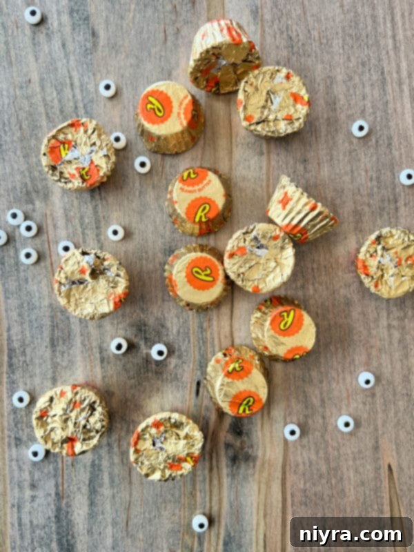Reese's Peanut Butter Cup Minis, candy eyeballs, and chocolate chips – key decorations for spider cookies.