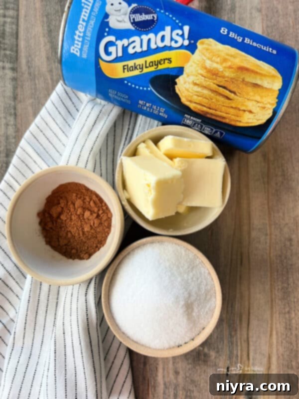 Freshly made Pumpkin Spice Air Fryer Biscuit Donuts on a cooling rack, glistening with spice sugar