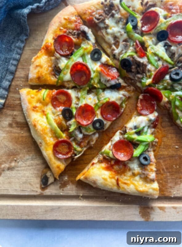 A delicious slice of supreme pizza with all its classic toppings.