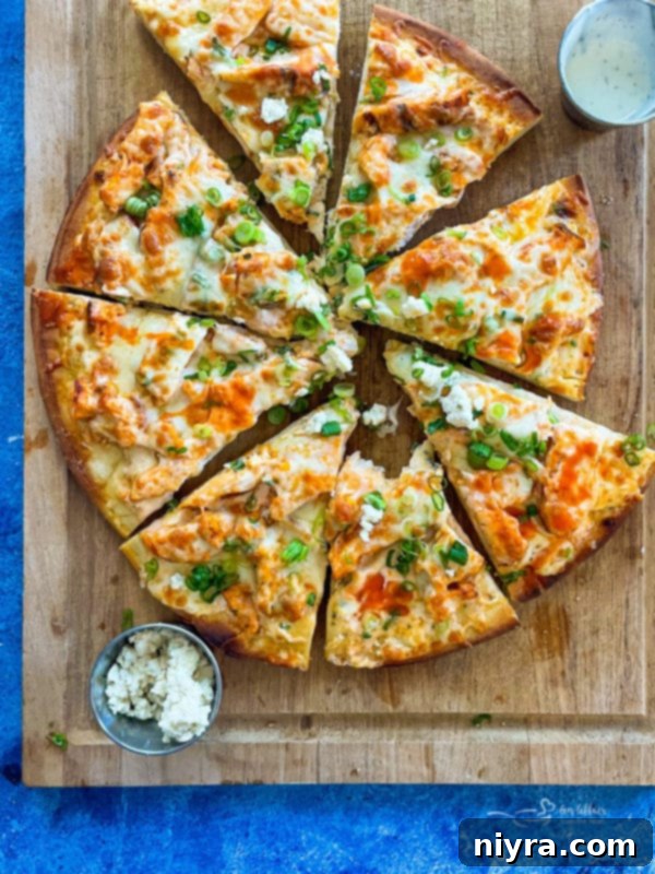 A sliced buffalo chicken pizza on a wood platter, highlighting other pizza possibilities.