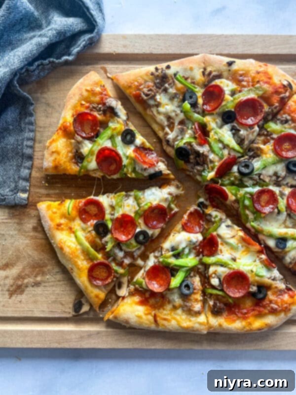 A supreme pizza, fully topped with ingredients before baking.