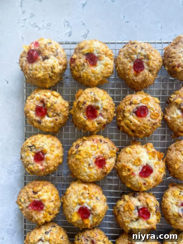 A close-up view of freshly baked Cherry Wink Cookies on a cooling rack.