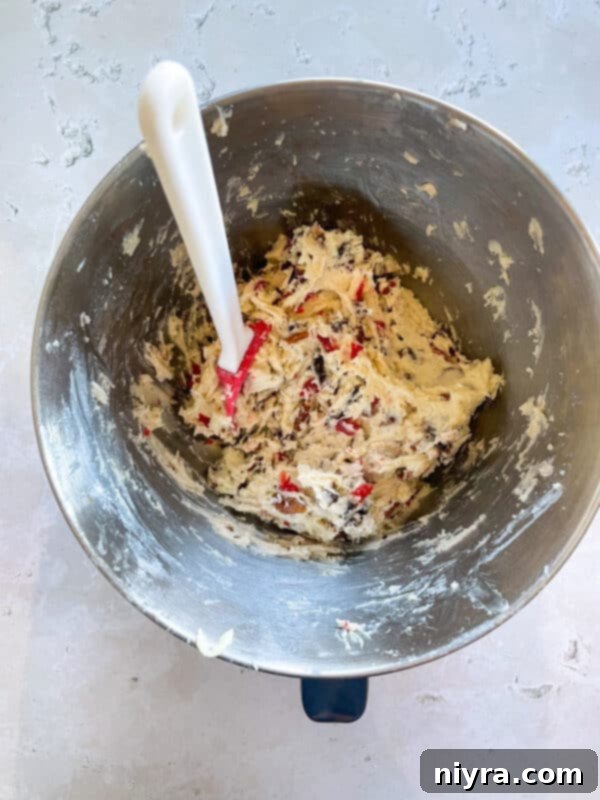 Cherry Wink cookie dough chilling in a bowl covered with plastic wrap.