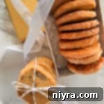 Orange ginger refrigerator cookies layered in a decorative box and tied with a string.