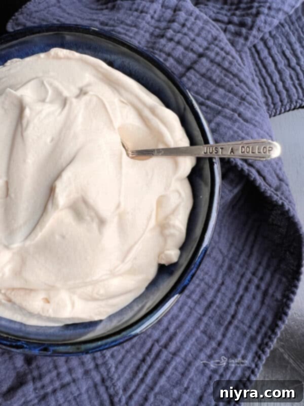Crafting Perfect Homemade Devonshire Cream 2 Devonshire Cream in a blue bowl with a silver spoon