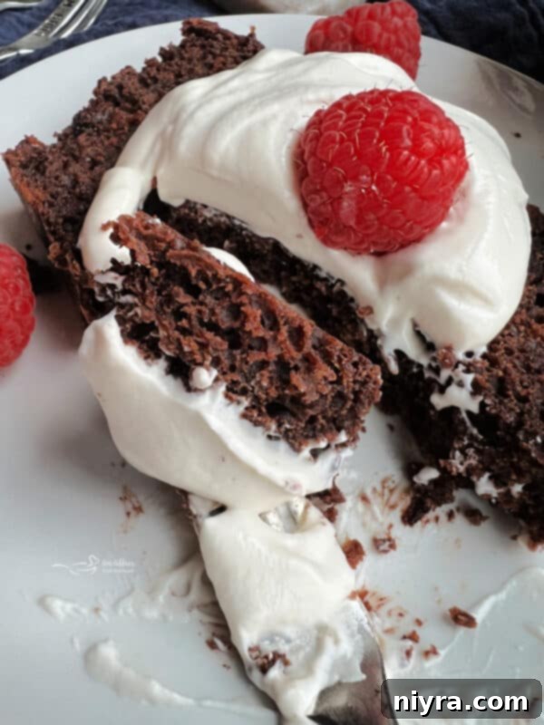 Chocolate Sauerkraut Pound Cake loaf on a cooling rack, with a slice already cut
