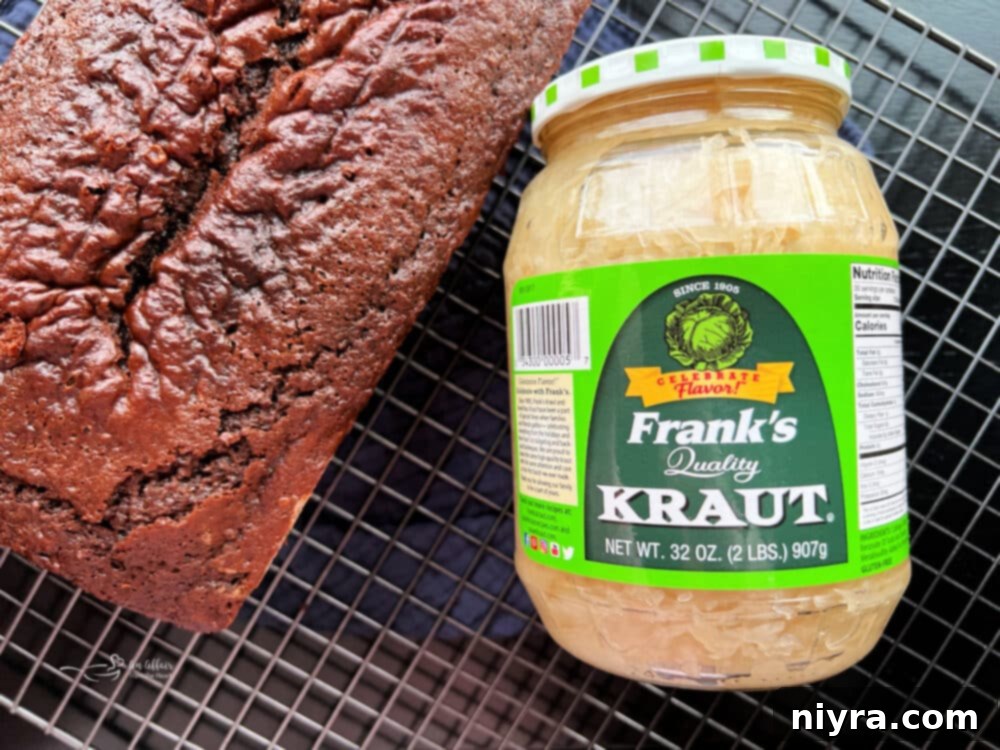 Chocolate Sauerkraut Pound Cake garnished with powdered sugar and fresh berries, ready for serving