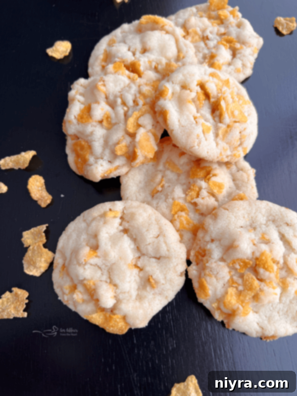 Close-up of golden brown cornflake crispy cookies on a white plate