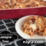 Quick Lasagna Bowl 2 A baked lasagna casserole in a dish with a piece on a white plate