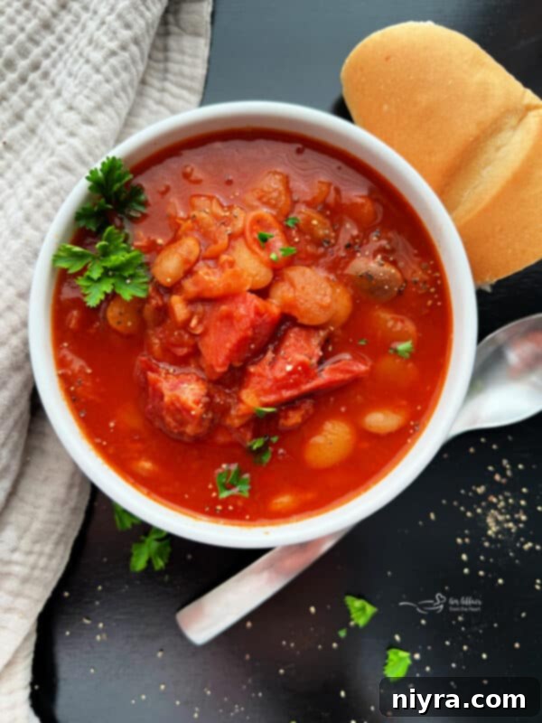 Grandmas Hearty Instant Pot Ham and Bean Soup 2 Instant Pot Ham and Bean Soup in a white bowl, garnished with parsley