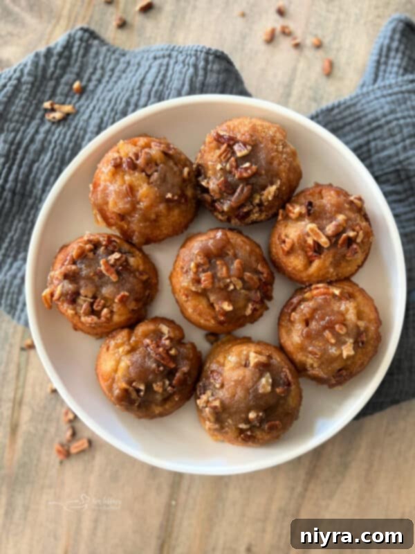 Close up of a single Banana Pecan Sticky Roll with a gooey topping