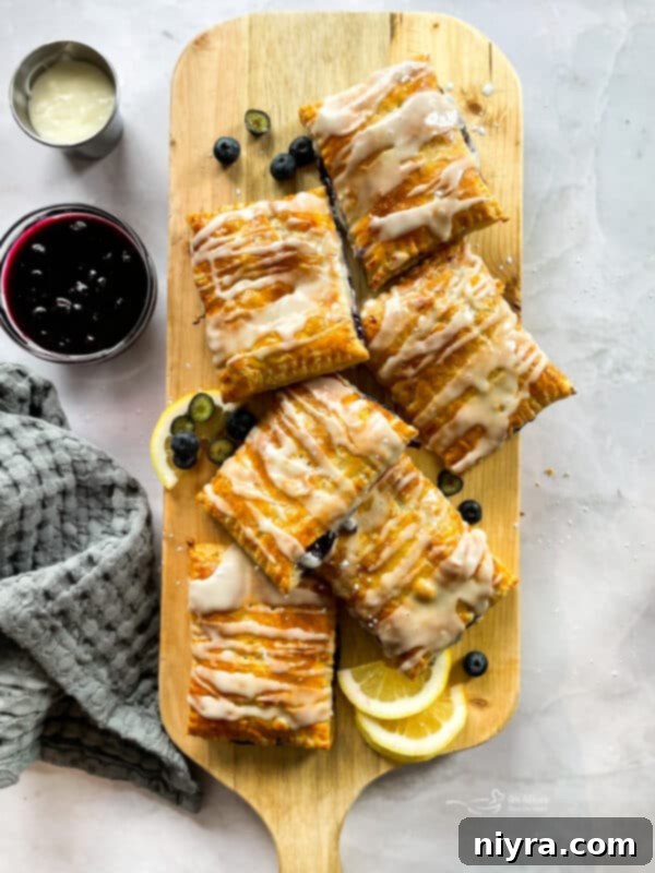 A close-up of a homemade blueberry toaster strudel with thick icing.