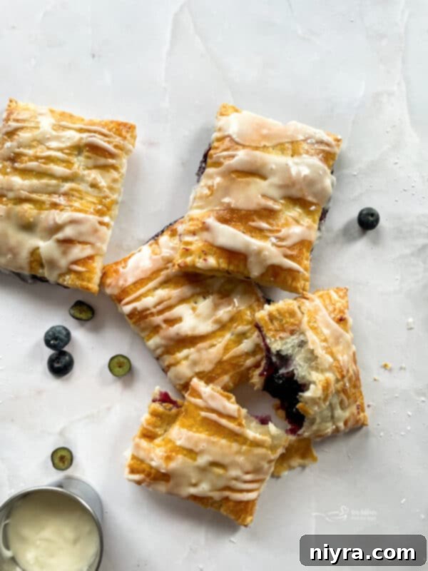 A selection of homemade blueberry toaster strudels, perfectly baked and ready to be glazed.