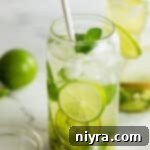 Refreshing Kiwi Mojito 16 Kiwi Mojito in a tall glass with a straw.