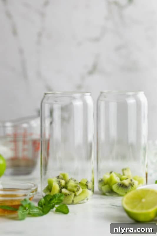 Refreshing Kiwi Mojito 5 First step: Peeled and diced kiwi fruit in a tall glass
