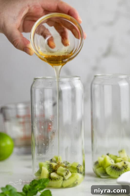 Refreshing Kiwi Mojito 7 Third step: Muddling kiwi, mint, lime, and honey with a muddler