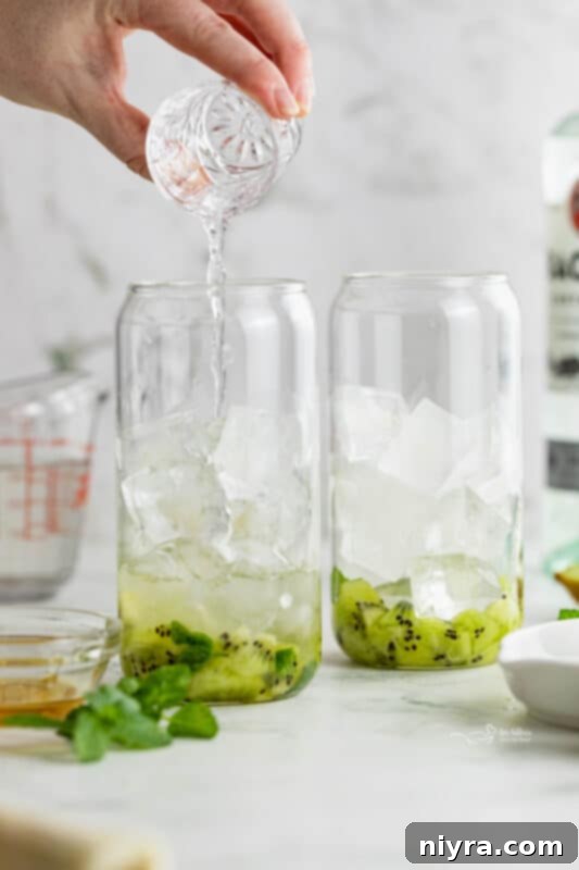 Refreshing Kiwi Mojito 9 Fifth step: Adding rum and topping with soda water, then garnishing