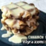 Waffles stacked on a blue plate with text 'Cinnamon Roll Waffles